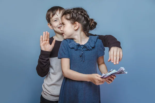 Girl holding money bills in the hands of a boy trying to take aw — Stock Photo, Image