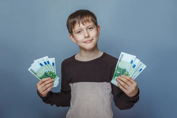 Boy teenager European appearance ten years holding a wad of mone — Stock Photo, Image