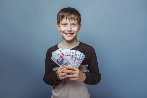 Boy teenager European appearance ten years holding a wad of mone — Stock Photo, Image