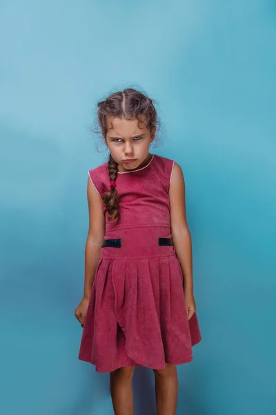 Girl European appearance decade angry frowns on blue background — Stock Photo, Image