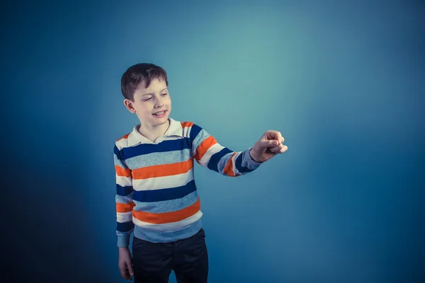 Boy teenager European appearance ten years writing in the air on — Stock Photo, Image