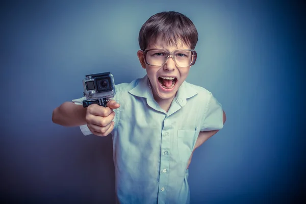 A boy of about ten European appearance in light brown shirt and — Stock Photo, Image