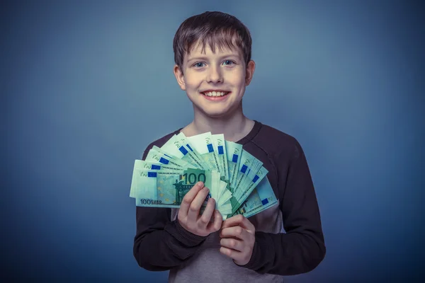 Teenager boy Brown European appearance in brown jacket holding a — Stock Photo, Image