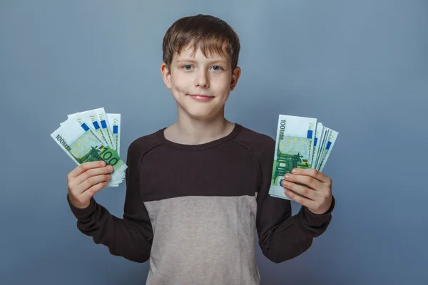 Boy teenager European appearance  ten years  holding a wad  of — Stock Photo, Image