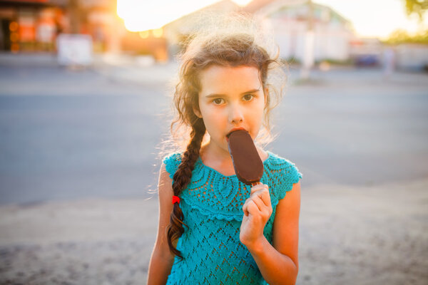 Teen girl eating ice cream in the summer the outside bites lifes