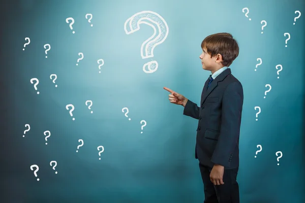 Teenage boy pointing at a businessman standing with his back bac — Stock Photo, Image