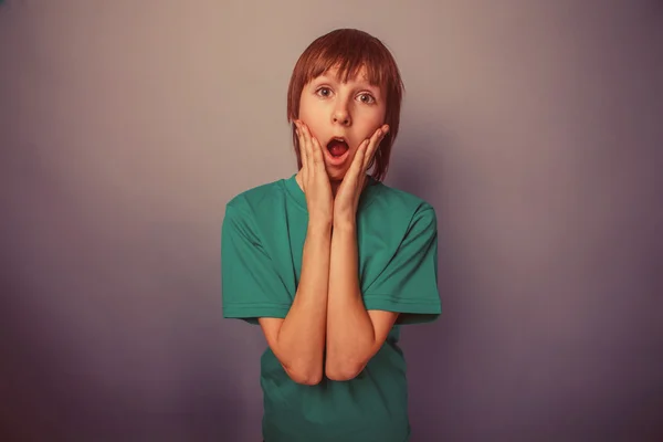 European-looking boy of ten years surprise, opened his mouth on — Stock Photo, Image