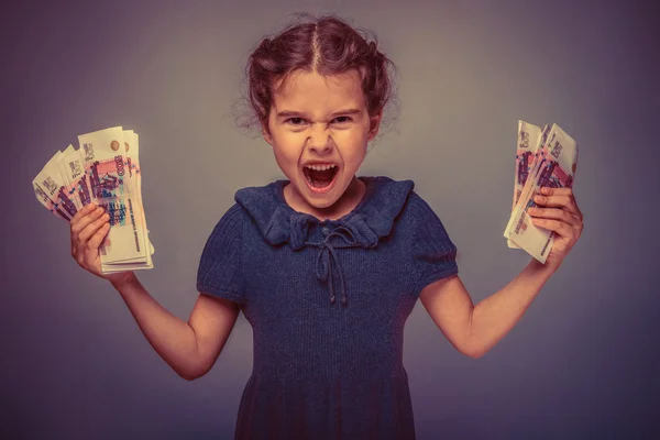 Teen girl of European appearance holds five denominations of mon — Stock Photo, Image