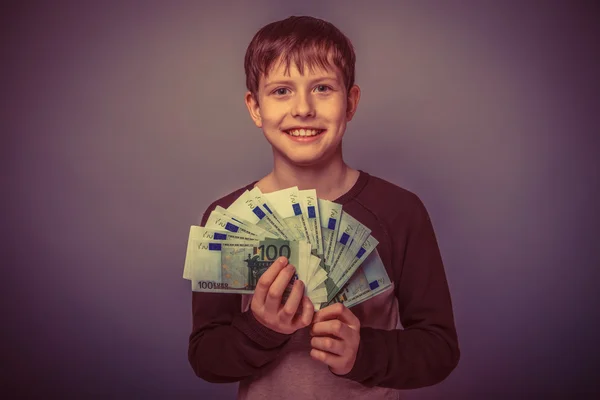 Teenager boy Brown European appearance in brown jacket holding a — Stock Photo, Image