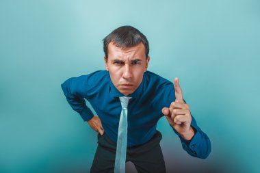 a man of European appearance thirty years threatens finger on a 