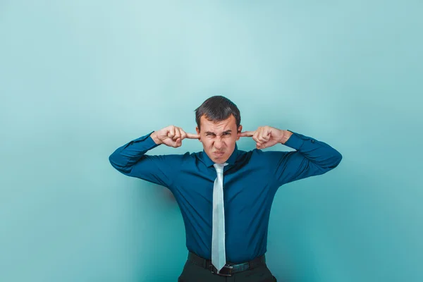 A man of European appearance thirty years his ears fingers on a — Stock Photo, Image