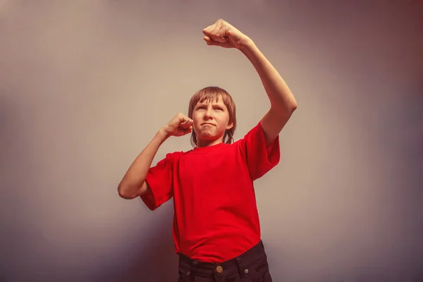 Boy, teenager, twelve years  red  in shirt,  showing his fists r — Stock Photo, Image