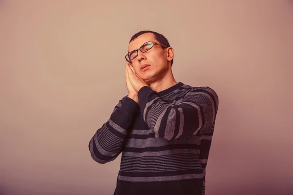 European-looking man of 30 years  in glasses  wants to sleep ret — Stok fotoğraf