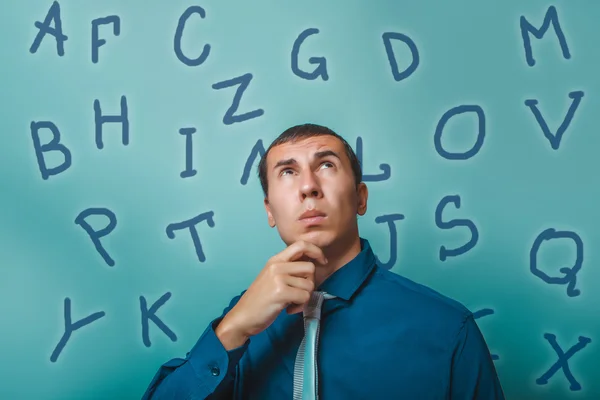 Man male teacher businessman looking up thinking alphabet letter — Zdjęcie stockowe