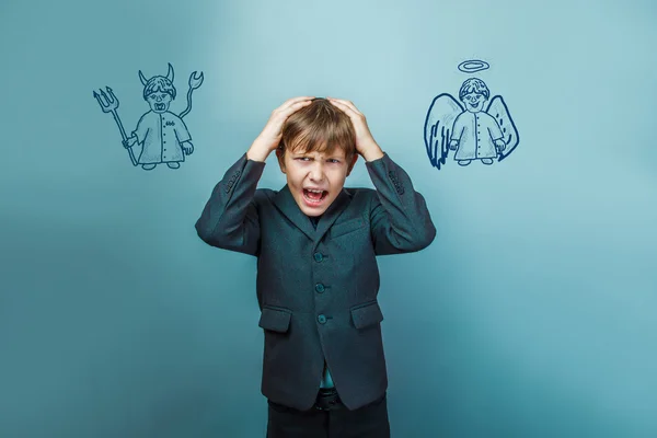 A boy of twelve European appearance in a suit holding a blank sh — Stock Photo, Image