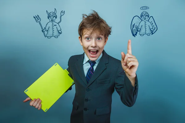 A boy of twelve European appearance in a suit holding a blank sh — Stock Photo, Image