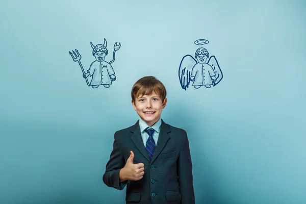 A boy of twelve European appearance in a suit holding a blank sh — Stock Photo, Image