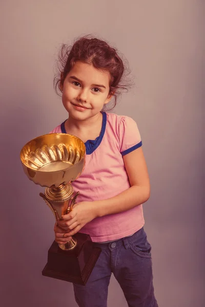 Niña de 6 años de apariencia europea sostiene una taza en su h — Foto de Stock