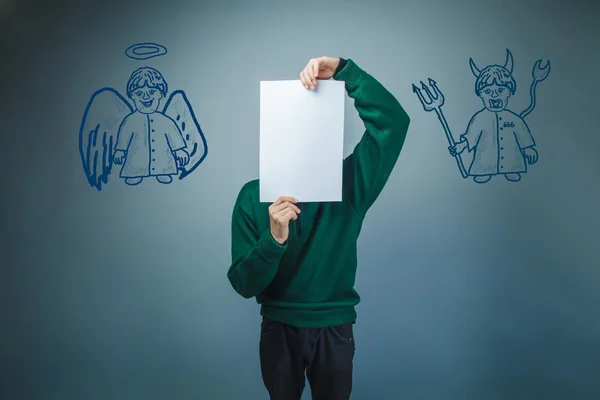 A boy of twelve European appearance in a suit holding a blank sh — Stock Photo, Image