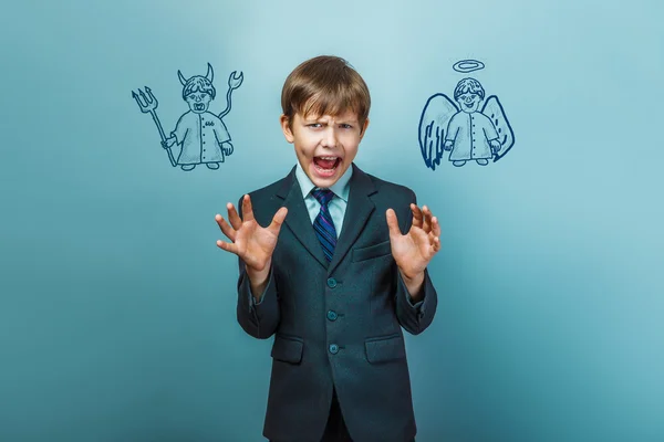 A boy of twelve European appearance in a suit holding a blank sh — Stock Photo, Image