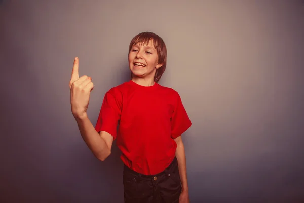 European-looking boy of ten years shows number one finger on a g — Stock Photo, Image