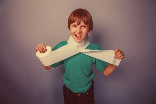 European-looking boy of ten years with toilet paper, wants to us — Stock Photo, Image