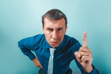 a man of European appearance thirty years threatens  finger on a