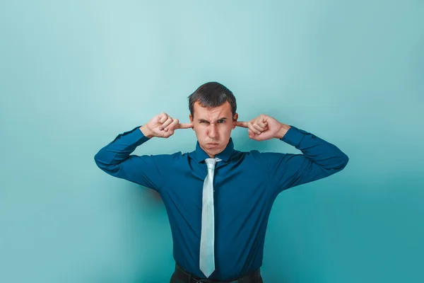 A man of European appearance thirty years his ears fingers on a — Stock Photo, Image