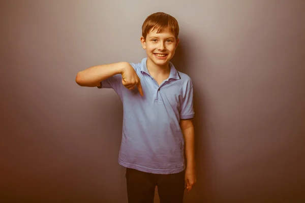 Boy teenager European appearance in a blue shirt brown hair show — Stock Photo, Image