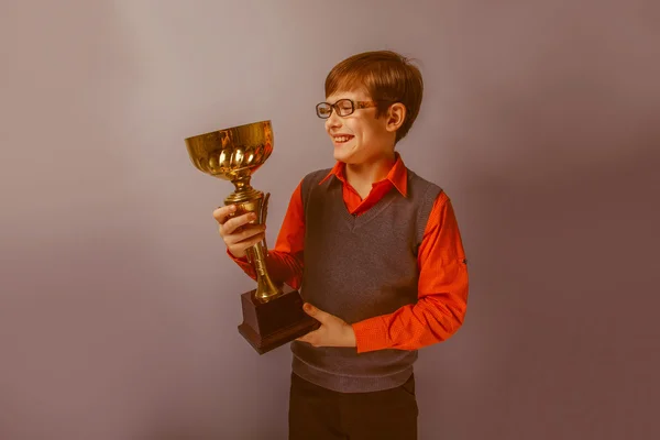 European-looking  boy of  ten years in glasses holding a cup awa — Stock Photo, Image