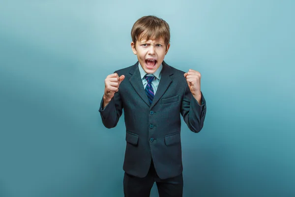 A  boy of twelve European appearance  in a suit shouting angry o — 图库照片