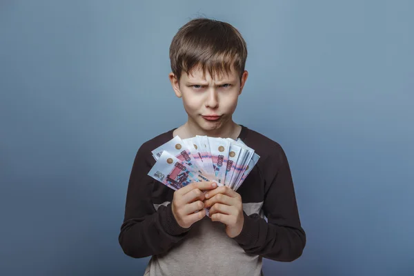 Boy  teenager European appearance ten years holding a wad of mo — Stock Photo, Image
