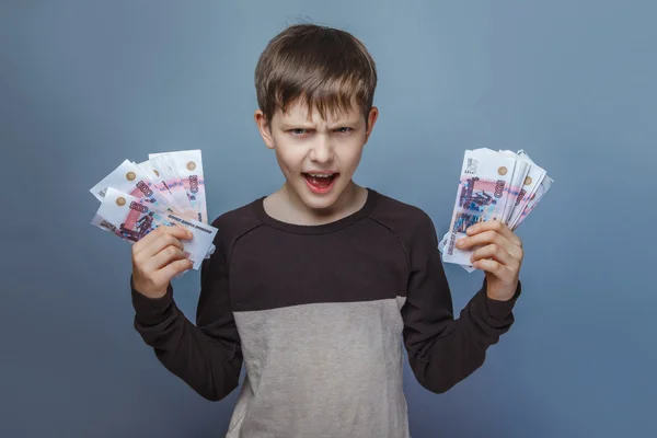 Boy  teenager European appearance ten years holding a wad of mon — Stock Photo, Image