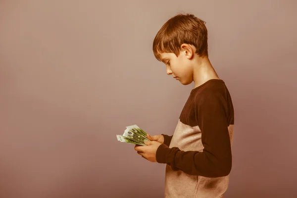 Boy teenager  European appearance  ten years  holding a wad  of — Stock Photo, Image