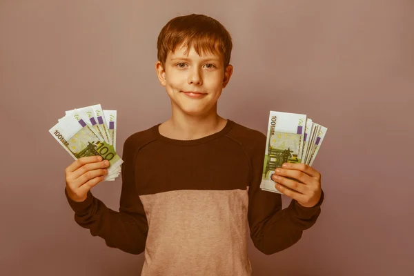 Boy teenager European appearance  ten years  holding a wad  of m — Stock Photo, Image