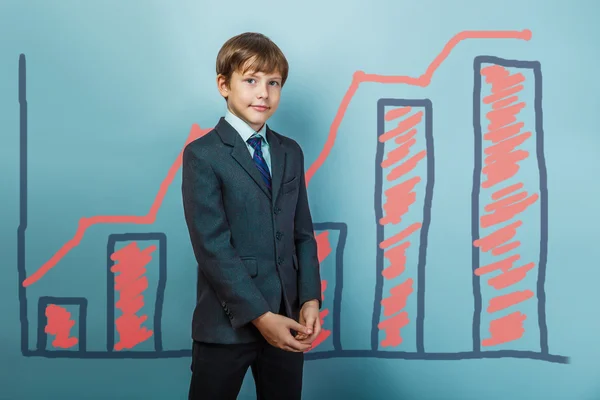 A boy of twelve European appearance in a suit holding a blank sh — Stock Photo, Image