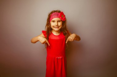 Girl European appearance haired child of seven in red bright dre