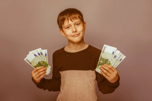 Boy teenager European appearance ten years holding a wad of mone — Stock Photo, Image