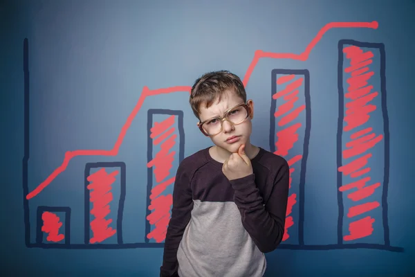 A boy of twelve European appearance in a suit holding a blank sh — Stock Photo, Image