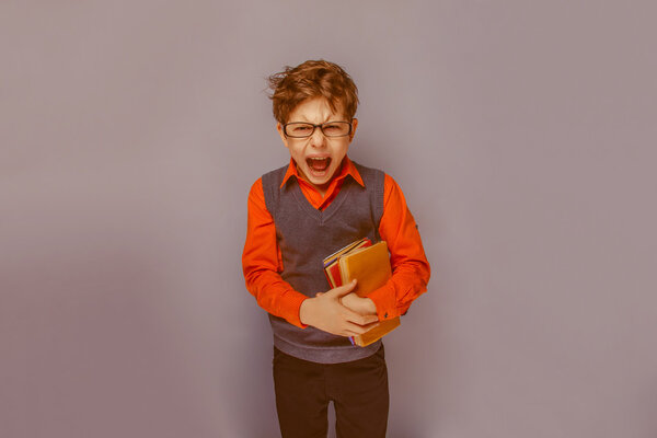 European-looking  boy of ten years in glasses  opened his mouth