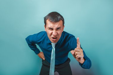 a  man of European appearance thirty years threatens finger on a