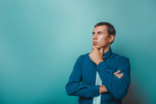 A man of  European appearance thirty years thinking hand on chin — Stock Photo, Image