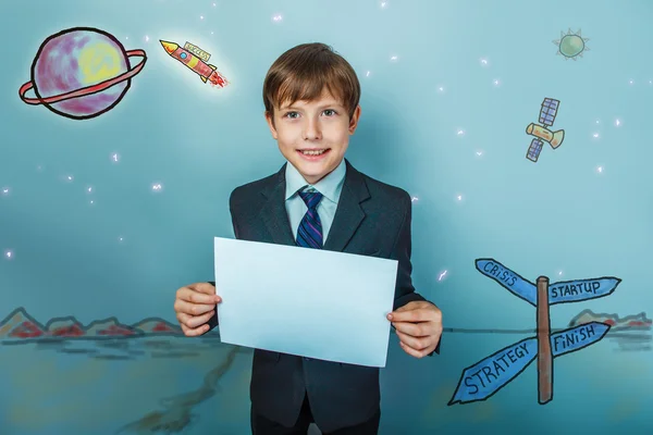 A boy of twelve European appearance in a suit holding a blank sh — Stock Photo, Image