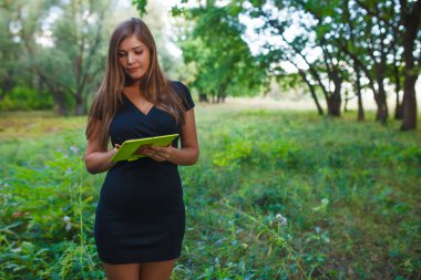 Girl European appearance young blond hair in a short black dress
