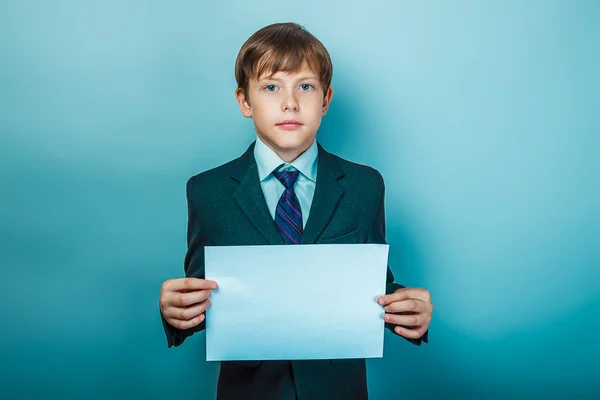 European appearance teenager boy in a business suit holding a wh — ストック写真