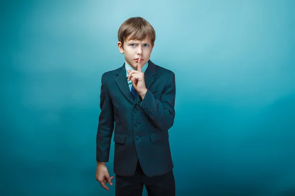 European appearance teenager boy in a business suit put his fing — Stock Photo, Image