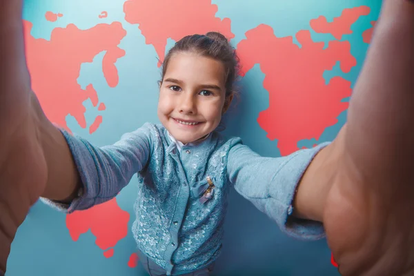 Girl teen shouting stretched her arms behind world map education background — Zdjęcie stockowe