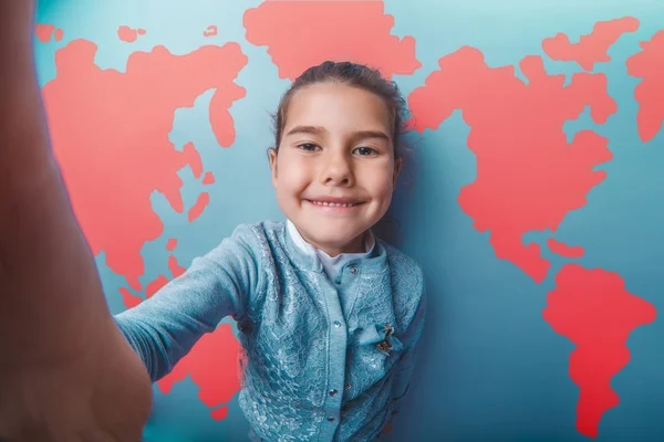 Girl teen shouting stretched her arms behind world map background — ストック写真