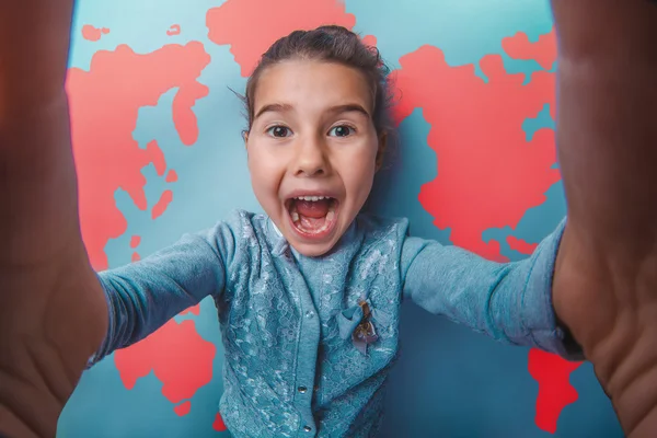 Teen girl shouting stretched her arms behind world map background — Stock fotografie