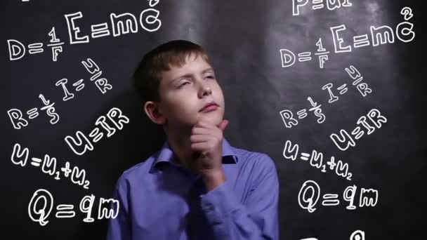 Teen boy thinks formula physics science scientist genius — Stock Video